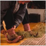 Stuffing hay into fur shoes.jpg